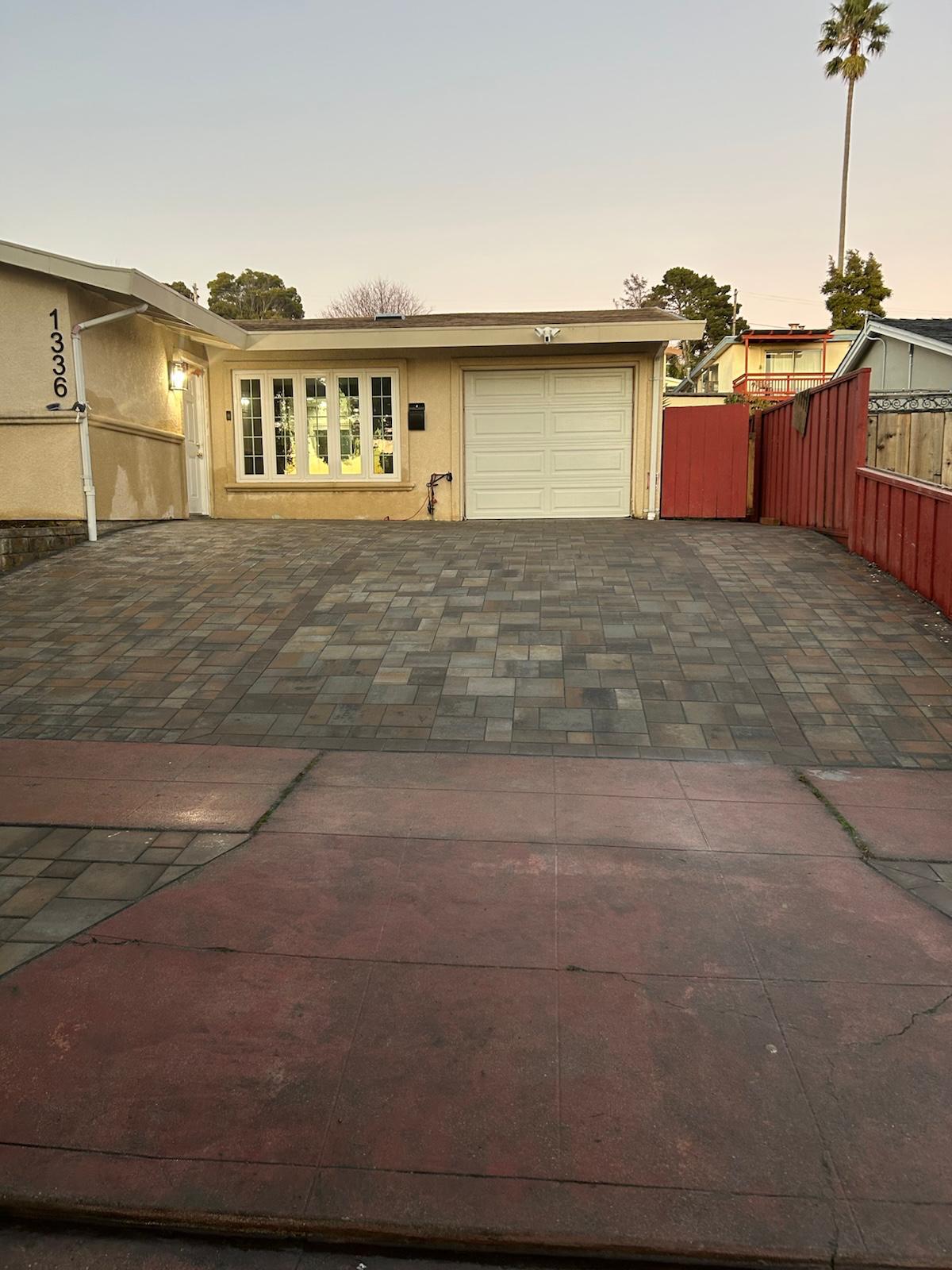 After: completed multi-tone paver driveway in front of the home